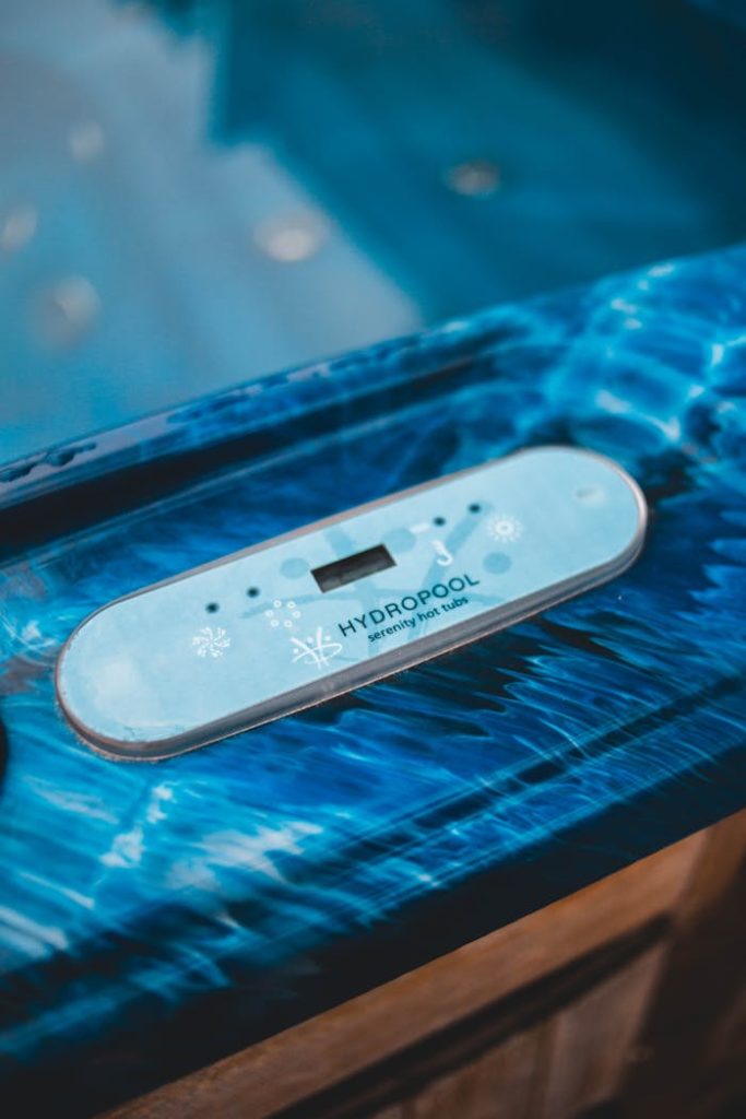 Offerings Close-up of a hot tub control panel with blue water reflections indoors.
